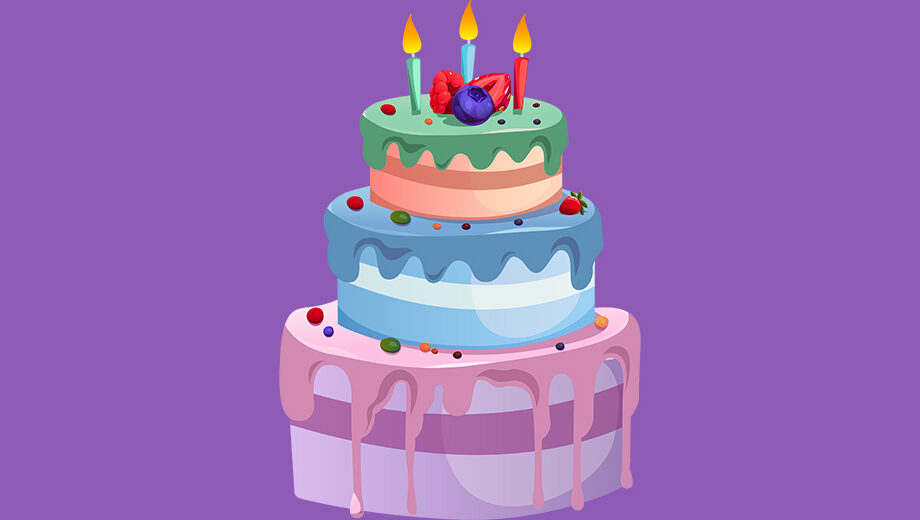 a colorful multi tiered birthday cake with three lit candles